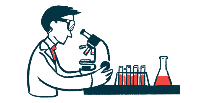 A researcher in a laboratory looks into a microscope.