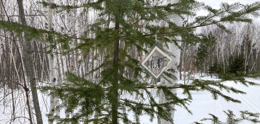 hope | ALS News Today | A diamond-shaped piece of artwork reads "HOPE" and hangs from a balsam fir tree along a cross-country skiing trail.