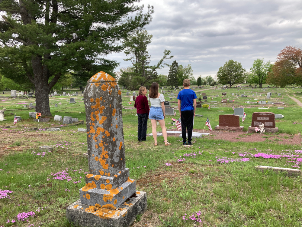 memorial day cemetery | ALS News Today | A photo taken from behind shows Kristin's mom and children visiting family graves in Michigan on Memorial Day.