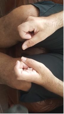 Photo of Juan's hands, fingers curled
