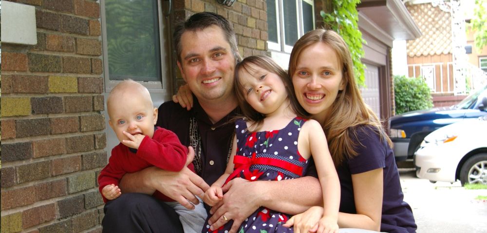 caregiving for a spouse | ALS News Today | A family photo from 13 years ago show Todd and Kristin posing in front of a home, holding their two young children