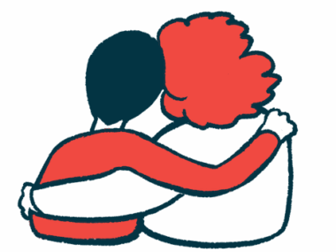 Two people are pictured from behind with their heads together and their arms around each other.