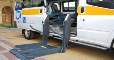 A wheelchair-accessible van with its door open revealing a wheelchair lift