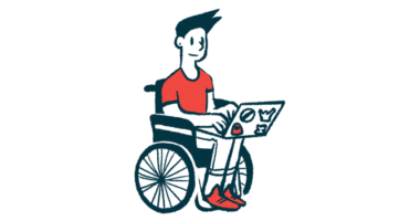 A person in a wheelchair types on a laptop.