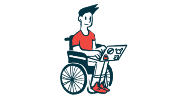 A person in a wheelchair types on a laptop.
