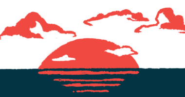 The sun sets over the ocean, with clouds in the background.