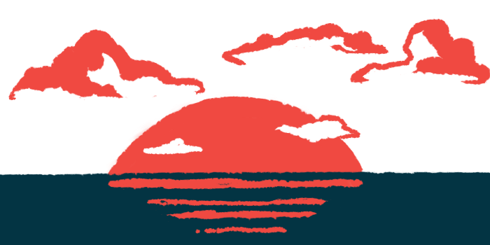 The sun sets over the ocean, with clouds in the background.