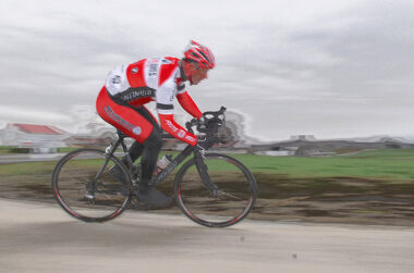 A man rides a bicycle in a competitive event.