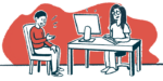 A patient sits in a chair speaking to a doctor at a desk.