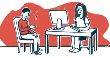 A patient sits in a chair speaking to a doctor at a desk.