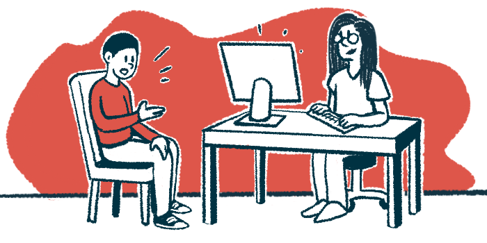 A patient sits in a chair speaking to a doctor at a desk.